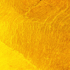 The Gold stone texture for background. gold wall background.