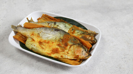 Delicious presto milkfish in a white plate. bandeng presto