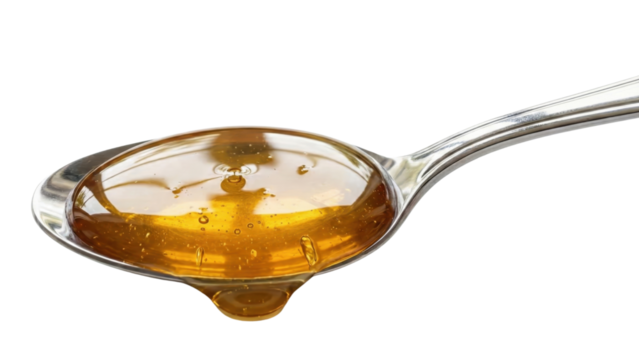 Golden Nectar Droplet: A macro shot captures the captivating moment of honey gracefully clinging to a spoon, with a glistening droplet on the verge of falling.