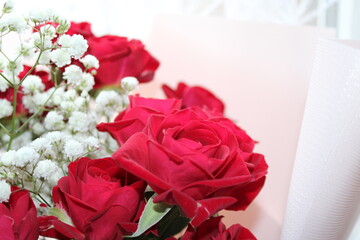 Beautiful bouquet of red roses with delicate white baby’s breath arranged elegantly for a special occasion