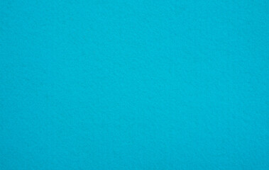 Turquoise background made of soft felt fabric.Turquoise color photo.