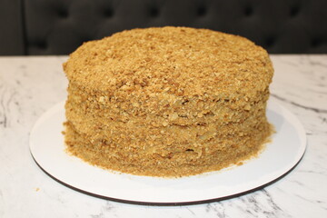 Delicious layered cake with crumbly topping and smooth texture in a kitchen setting