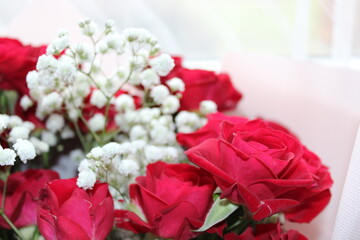 Vibrant red roses and delicate white flowers arranged beautifully for a special occasion indoors