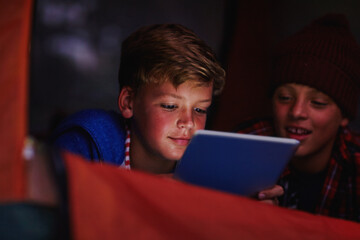 Night, children and tablet in fort with ebook for reading, adventure story and bonding together. Late, friends or boys in tent with tech for online fiction novel, kids storytelling app or connection.
