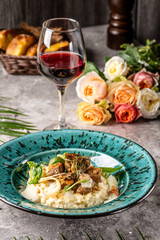 Romantic mushroom risotto with red wine glass