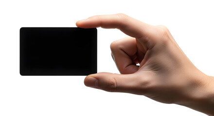 Hand holding small black square against a dark background in studio