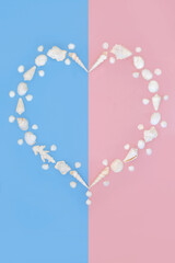 Heart shaped seashell pearl wreath on pink blue. Romantic natural seaside symbol of love for Valentines, anniversary or birthday greeting card. 