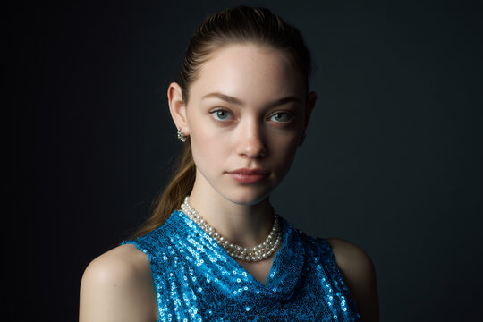 Close-up portrait of a woman in a blue dress, elegant in appearance 