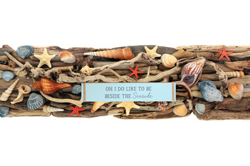 I do Like to be by the Seaside sign on driftwood and seashell banner decoration background on white. Summer holiday, vacation, travel theme. 