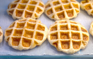 Waffle, Golden baked waffles on shelf, Waffle shop close-up, showcasing a crisp and appetizing texture. Perfect for food design, menus, and bakery advertising