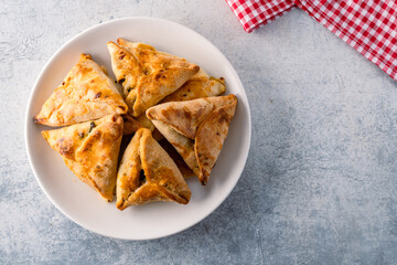 Homemade triangular pastry with spinach and cheese. A traditional Middle Eastern dish.