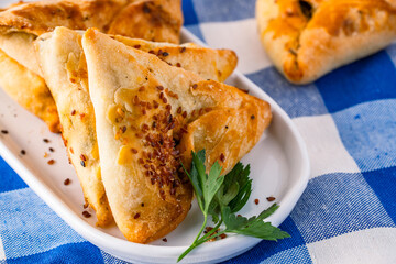 Homemade triangular pastry with spinach and cheese. A traditional Middle Eastern dish.