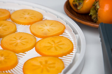 Sliced persimmon on a white background. Selective focus.