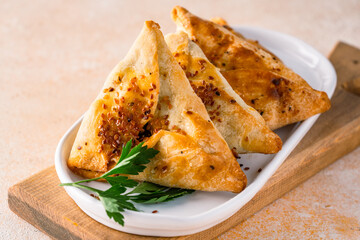 Homemade triangular pastry with spinach and cheese. A traditional Middle Eastern dish.