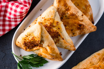 Homemade triangular pastry with spinach and cheese. A traditional Middle Eastern dish.