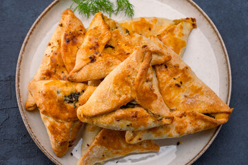 Homemade triangular pastry with spinach and cheese. A traditional Middle Eastern dish.