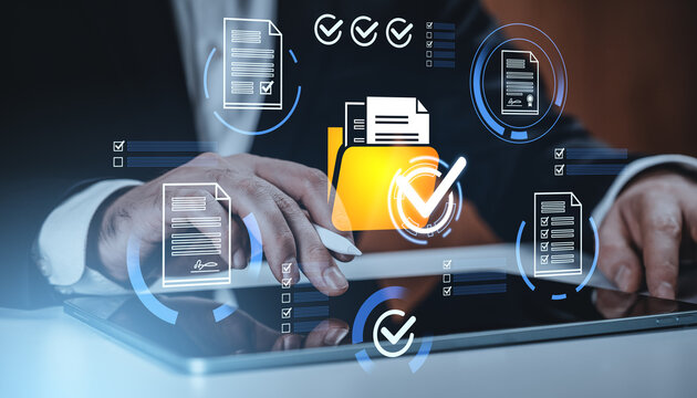 Businessman using tablet with digital document icons and checkmarks representing data approval and file management concept on abstract background.