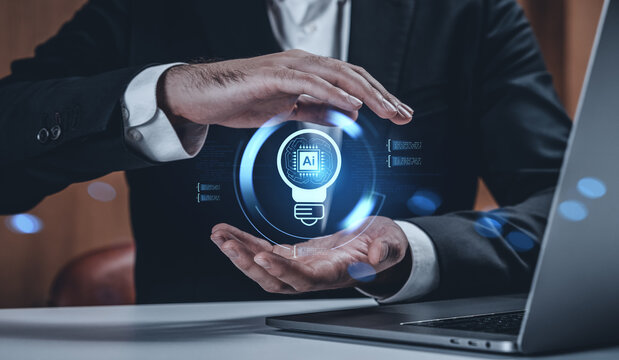 Businessman presenting AI technology concept with glowing digital lightbulb icon between hands in futuristic tech environment at workplace table. - Powered by Adobe