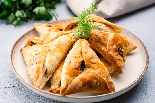 Homemade triangular pastry with spinach and cheese. A traditional Middle Eastern dish.