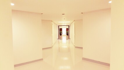 Empty Hallway with White Walls and Tile Floor