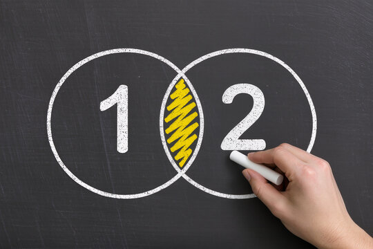 Venn diagram on blackboard, Business man drawing two circles