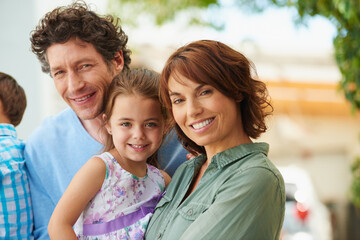 Portrait, parents and child with smile in backyard of home for summer bonding, care and support for connection. Security, happy people and kids together on weekend, outdoor and love for family time