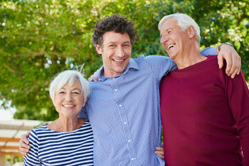 Elderly parents, hug and son in backyard with smile, connection or bonding on summer break. Portrait, happy family or people outdoor with embrace, support or relatives together in springtime.