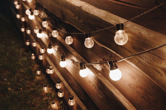 Warm string lights on wooden fence