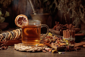 Cup of herbal tea with various dried herbs, flowers, and spices.
