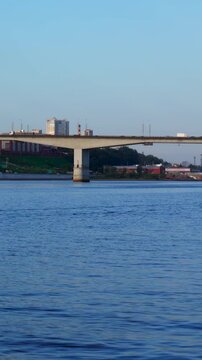 Boat navigating on dnieper river passing under paton bridge in kyiv. Clip