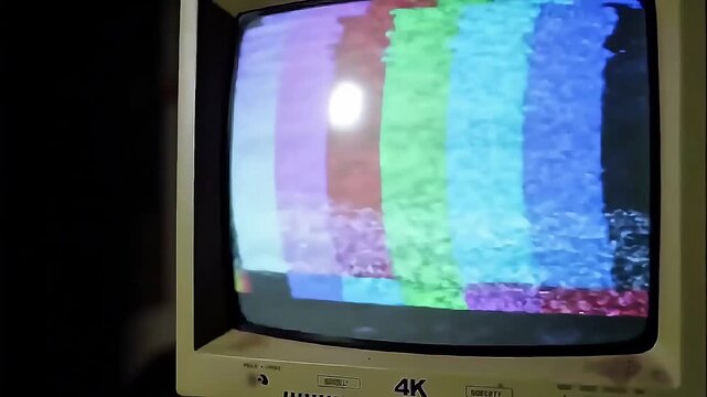 Vintage television screen displaying colorful test pattern for broadcast setup