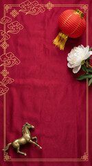 Flatlay Red Chinese lantern, golden horse, white flower, festive decor