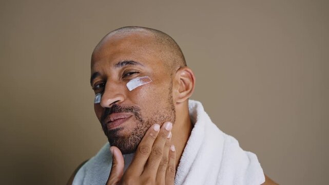 Beauty portrait of middle-aged hispanic black handsome man on colored background, concepts about beauty treatment, skincare and cosmetics for men