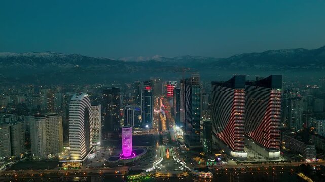 Drone aerial view of skyscrapers in night Batumi City, Georgia