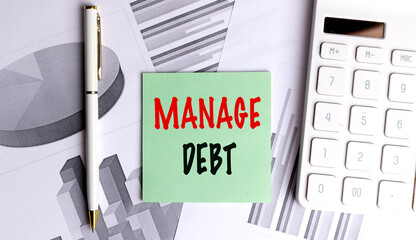 Manage debt note on financial charts with pen and calculator for budget planning concept