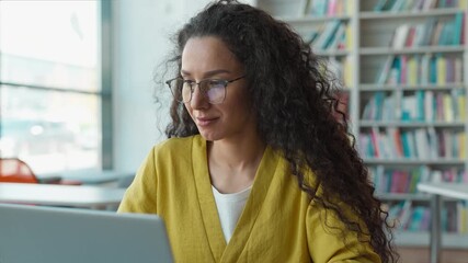 Latina Hispanic woman student use laptop technology library female girl typing on computer gadget cyberspace virtual project diploma homework elearning modern study smart education college university