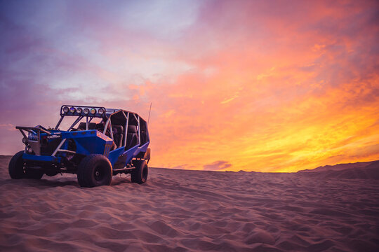 Buggie car in Huacachina desert at sunset - Ica, Peru