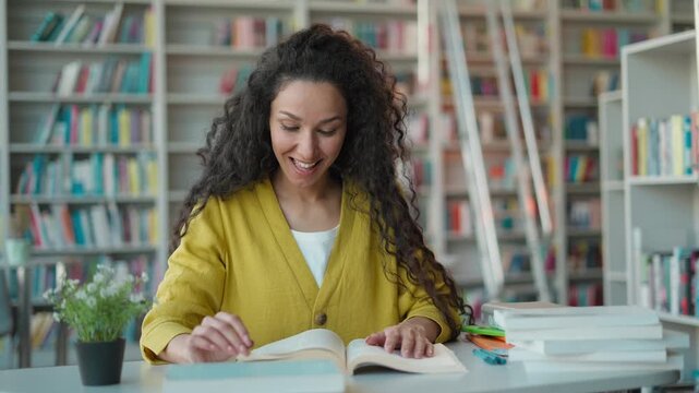 Amazed surprised smiling Hispanic woman student reading book in library Latino female girl say wow hobby reader study learning university high school college exam preparation wonder textbook education