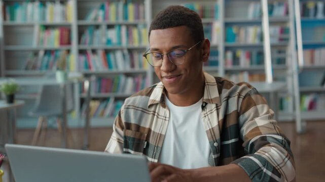 Clever student African American man come sitting typing laptop in university library male guy computer start work exam preparation elearning online books diploma session high school academy technology