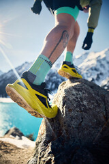 Man running at snow trail in the winter mountains