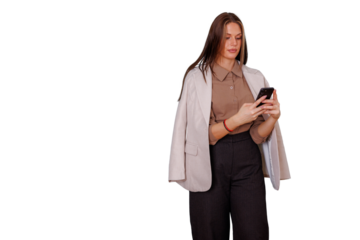 Businesswoman standing, browsing smartphone, texting, managing career and digital communication