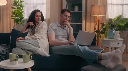 Multiethnic couple family problem crisis Caucasian male man busy playing video game laptop ignoring sad Hispanic female woman at home upset lonely girlfriend gadget addict boyfriend wife conflict mood - Powered by Adobe