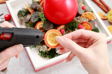 Florist at work: woman making traditional christmas decorations. Step by step, tutorial.