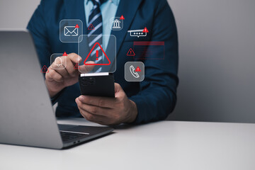 Cybersecurity warning on mobile phone showing alert messages and phishing scams targeting email, bank, and personal data. online safety and data protection while using smartphone and laptop at home.