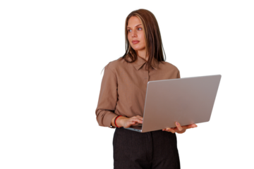 Woman standing, typing on laptop, gazing to the side with pensive expression against transparent background
