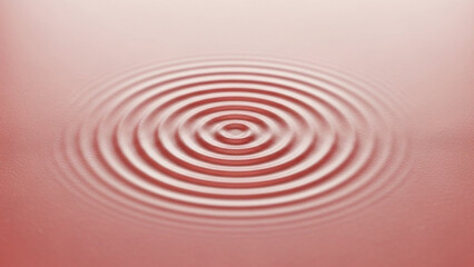 Circular ripples expanding outwards on a surface with a soft pink gradient background effect creating waves