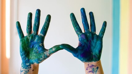 Hands covered in colorful paint, artistic expression and creativity.