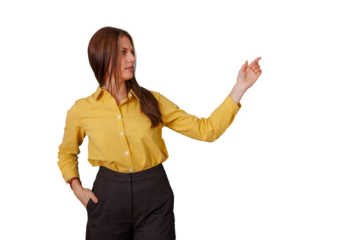 Businesswoman in yellow shirt presenting an idea, pointing at copy space on transparent background