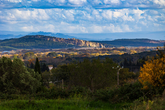 Panorama of the cliffs of Mornas and its fortress from the village of Saint-Alexandre