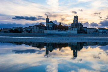 Reflection on the Rhône, from the left bank, of the city of Pont-Saint-Esprit with its churches...
